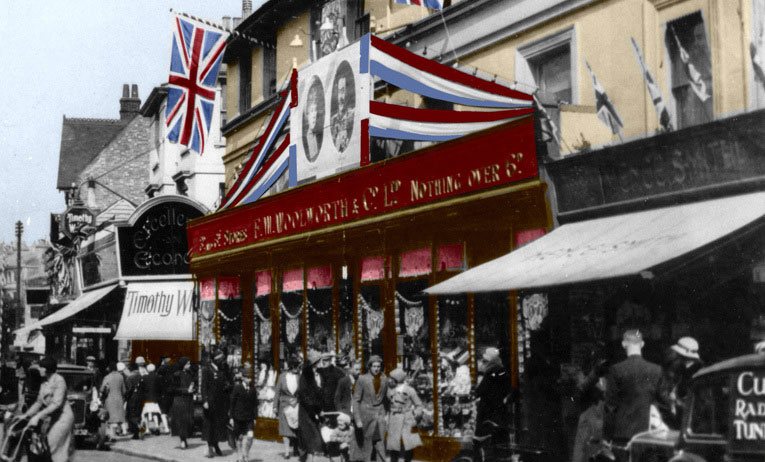 The exterior of F. W. Woolworth in Calverley Road, Tunbridge Wells dressed with bunting, flags and pictures of Their Royal Majesties for the Silver Jubilee of H. M. King George V and Queen Mary in 1935.