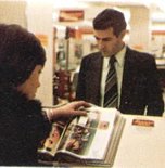 Customers browsing the Shoppers World Catalogue at the Order Point in-store