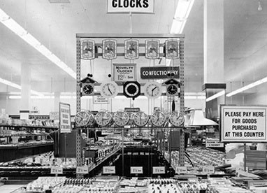One of our favourite pictures of Woolies in the Fifties - to look more modern a superstructure has been built on the leading end of the Fancy Goods counter to allow a bold display of the latest battery, mains-powered and wind-up clocks, which stretch over eight feet (2.5m) above the floor, almost all the way to the ceiling. They were visible from everywhere in the shop. It is said that the Store Manager's motto in Portsmouth was 'there's no time like the present, and no present like the time'