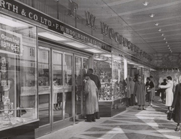 Customers take a sneak preview through the window of Oxford's new F. W. Woolworth store in 1957