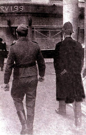 An infamous picture from World War II Jersey, as a uniformed British policeman and a German soldier walk side by side in St Helier, Jersey, Channel Islands CI.