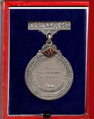 An F.W. Woolworth loyalty medal with an image of a mighty oak tree grown from an acorn on the obverse. These were originally awarded for 21 years service in Great Britain and Ireland