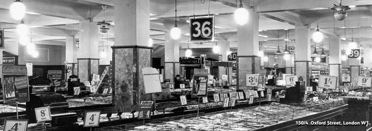 A typical salesfloor layout at Woolworth's shortly after World War II. The image shows Store 463 at 150-154 Oxford Street, London, near the British Museum in 1946.  The highest price on display at the time was four shillings and four pence, nearly nine times the pre-war maximum.