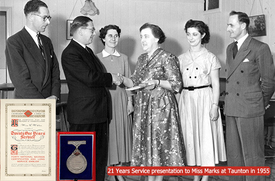 21 years service presentation to Miss Marks at Woolworth's Taunton in 1955. The award was made by the Store Manager, Mr. J.K.R. Mandley (shaking hands with Miss Marks), Mr Rouse looks on to their left, with Deputy Manager Bill Pell on the far right