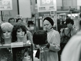 Women buying wigs in the closing down sale at Woolworths in San Francisco