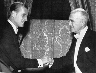H.R.H. the Duke of Edinburgh shakes hands with retired Woolworths Chairman W. L. Stephenson, ackowledging the retailer's role as Commodore of the Royal Motor Yacht Club in the 1950s.