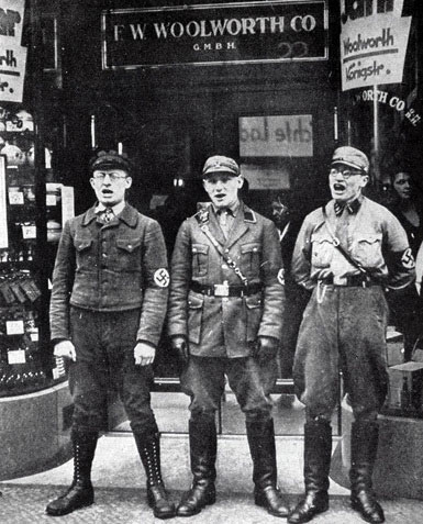 Soldiers from the German SA picket an F. W. Woolworth store with placards criticising the American owners and demanding a boycott of the chain