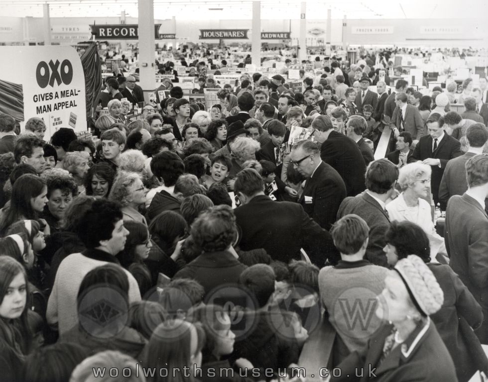 Woolco's Buying Manager Sid Stafford attempts to direct the traffic as 1,500 shoppers pack the aisles at Woolco, Thornaby on its opening day. Many left with a cookbook. No loaves and fishes, but lashings of gravy in all of Katie's dishes!