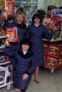 Store colleagues hold the latest issue of the Woolworths catalogue aloft in this publicity shot from 1983