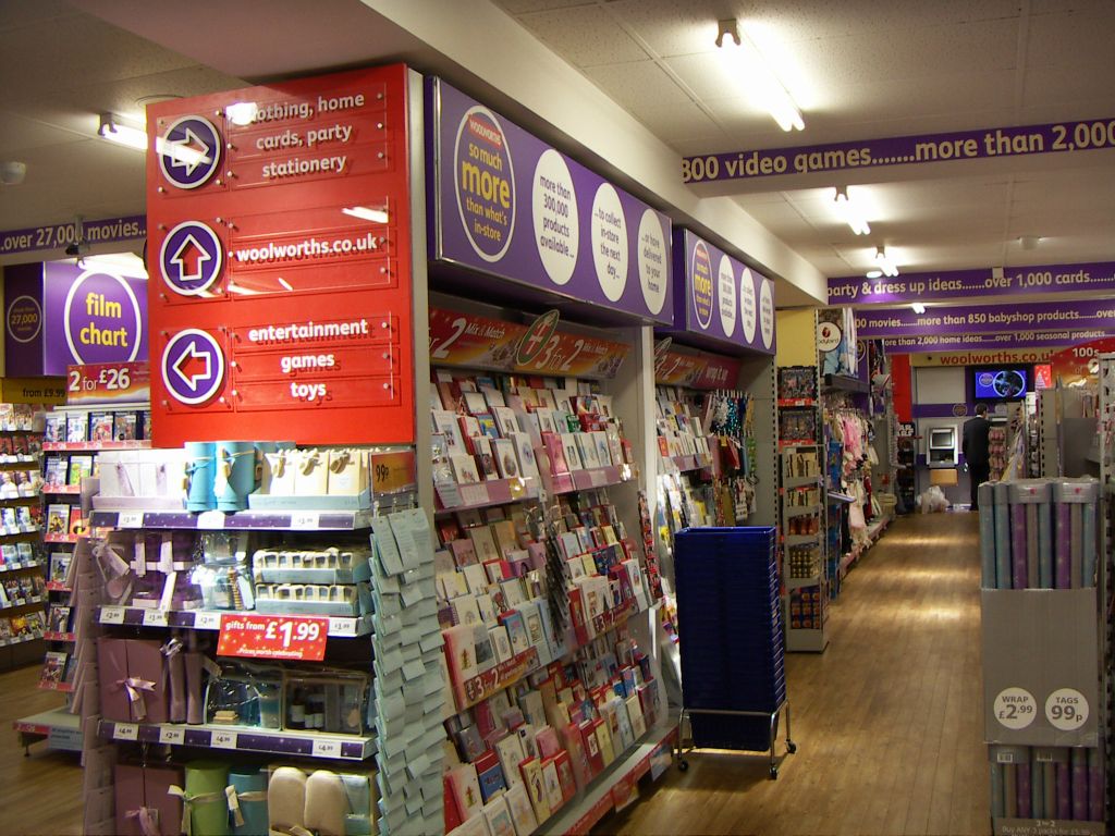 Tall illuminated racks were used to display greeting cards to advantage. Clever use of signage makes this fixture appear to be built into the Kingswood Woolworths store.