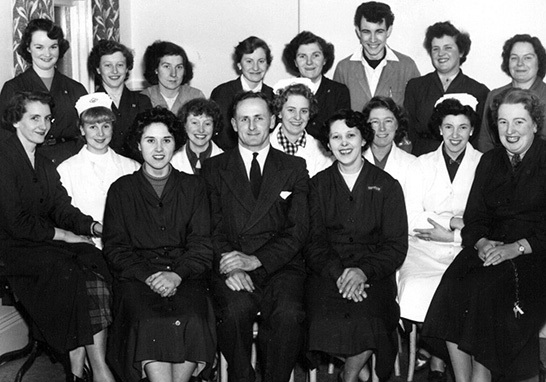 The Woolworth staff magazine 'The New Bond' published this picture of Mr. William Pell and the retailer's new team at '910 Dartmouth' in December 1955.
