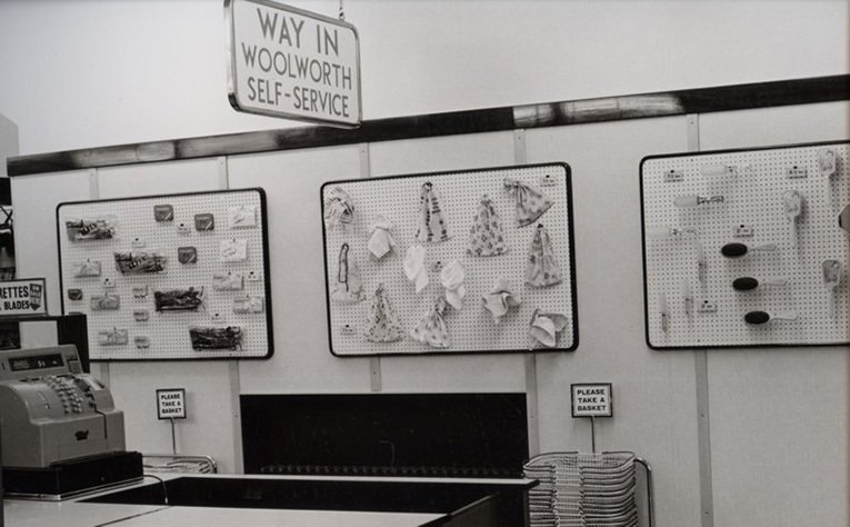 The view from the front of the new self service Woolworths store at Didcot, Oxfordshire in 1956. To ensure plenty of room for customers to circulate no merchandise was displayed on the walls near the checkout. Display boards were used instead.