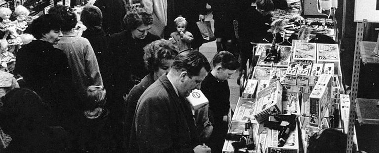 Toys in a bygone age, a father, mother and son, all smartly dressed, look at Airfix kits on sale in the F.W. Woolworth store in Briggate, Leeds, Yorkshire in 1959. Who knows what treat Santa delivered on Christmas morning!