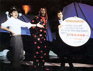 George Makulski, the Woolworths Marketing Director, hands over a cheque for £1.5m to superstars Lenny Henry and Griff Rhys-Jones (10th March 1988)
