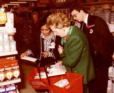 A famous local customer, the Prime Minister, the Rt Hon Margaret Thatcher MP (later Baroness Thatcher) shops for lightbulbs at Woolworths Grantham in 1987