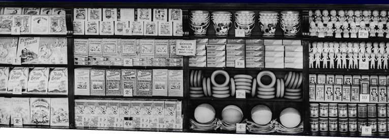This wall display of Summer Toys at Woolworth's in 1955 features jigsaw puzzles, tinplate buckets, rubber rings and beach balls