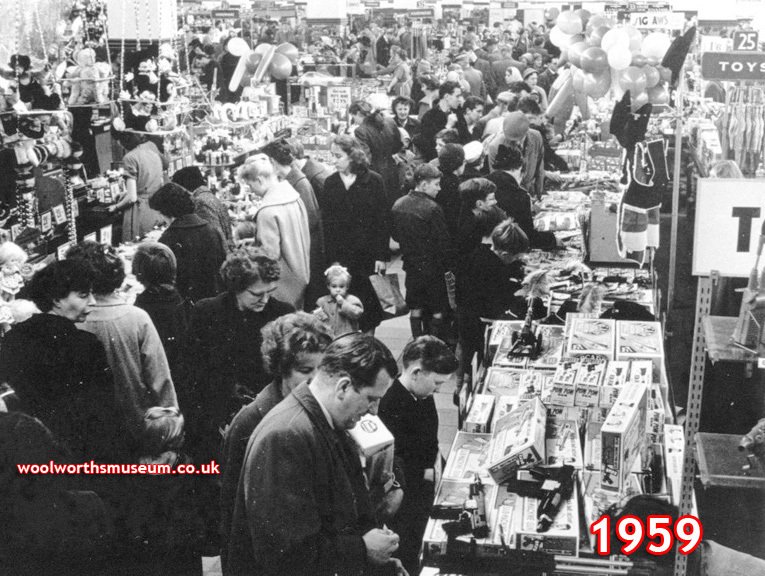 A family group choose Christmas Toys in the F.W. Woolworth store in Briggate, Leeds, West Yorkshire, UK in 1959. The picture shows how families would dress up to go to the shops in days gone by. In the foreground in this Saturday picture both dad and lad are wearing a tie.
